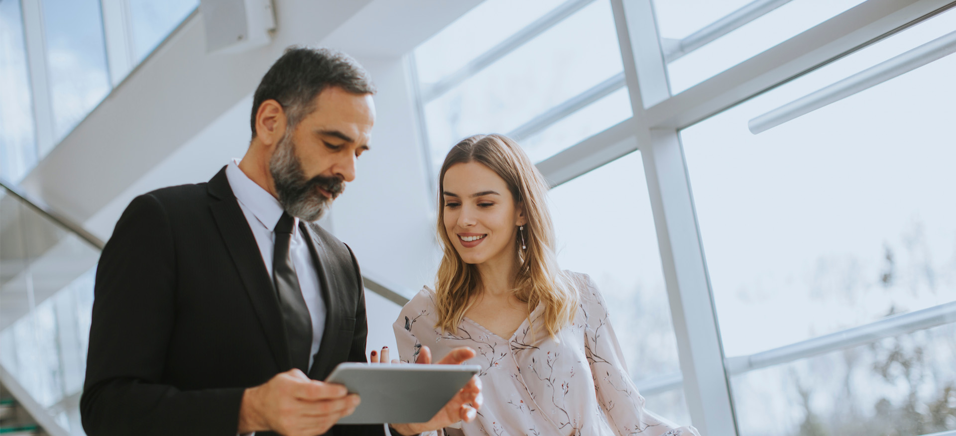 Photo of a financial professional and their client looking at a computer tablet