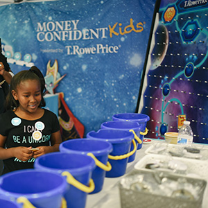 A child plays a game to learn about finance at an TRPI event.