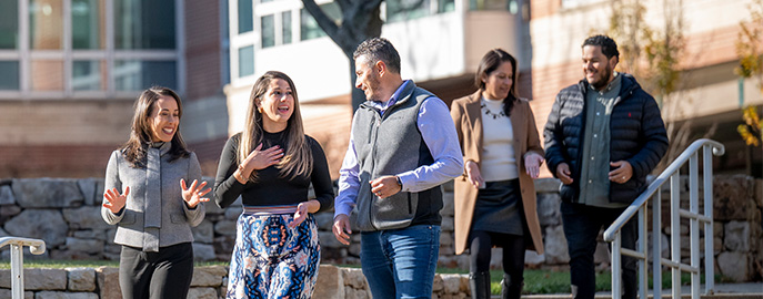 A group of a smiling employees outside